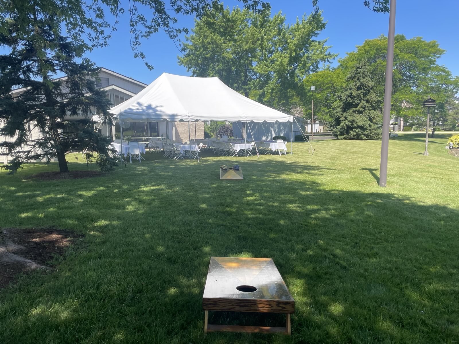 Lawn games and an event tent outside The Clubhouse
